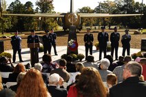 Family members, including those of recently honored aerial fire fighters and more than a thousand airmen of Charlotte's 145th Airlift Wing, North Carolina Air National Guard attend an annual memorial ceremony as a way to remember all airmen who had died in the year prior, whether a current or past member. Following a flyover of three C-130 Hercules, the aircraft used by the wing to accomplish its missions, the names are pronounced of any Air Guard member who has deceased over the last twelve months to a bagpipe rendition of "Amazing Grace," the formation of airmen at attention for a twenty-one gun salute, then a bugler performing "Taps," and the laying of a wreath in honor and remembrance of those who have passed. (National Guard photo by Senior Airman Laura Montgomery, 145th Public Affairs)