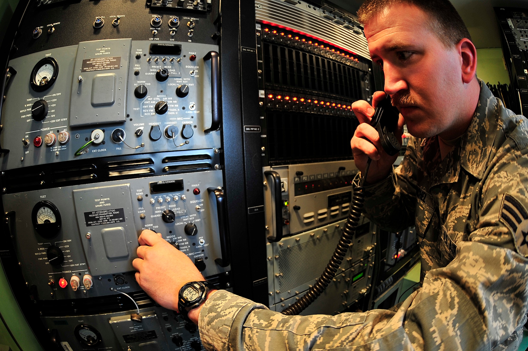 SOUTHWEST ASIA -- U.S. Air Force Senior Airman Lewis Winchel, 727th Expeditionary Air Control Squadron radio frequency communications technician, troubleshoots by monitoring radio frequencies used by the TPS-75 radar system Jan. 21, 2013. Winchel, deployed from Tomah, Wis., ensures that Kingpin operators in the Battle Command and Control Center are able to communicate with the aircraft executing the Air Tasking Order. (U.S. Air Force photo illustration/Tech. Sgt. Christina M. Styer)(RELEASED)