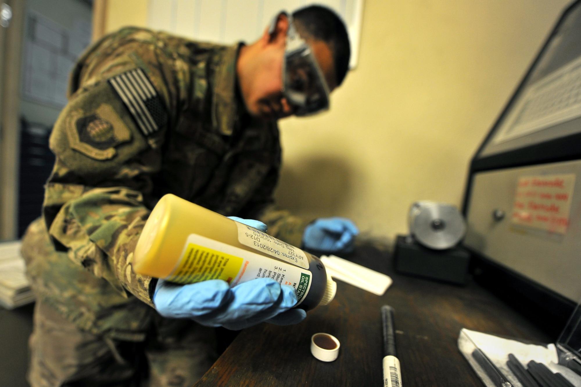Senior Airman Hugo Garcia, 455th Expeditionary Maintenance Squadron Non-Destructive Inspection lab Journeyman, prepares oil for analysis and collaboration at Bagram Airfield, Afghanistan, Jan. 25, 2013.  Using a spectrometric machine for oil analysis, the NDI lab can tell the aircraft maintainers exactly which engine components are wearing out and need to be replaced.  (U.S. Air Force photo/Senior Airman Chris Willis)