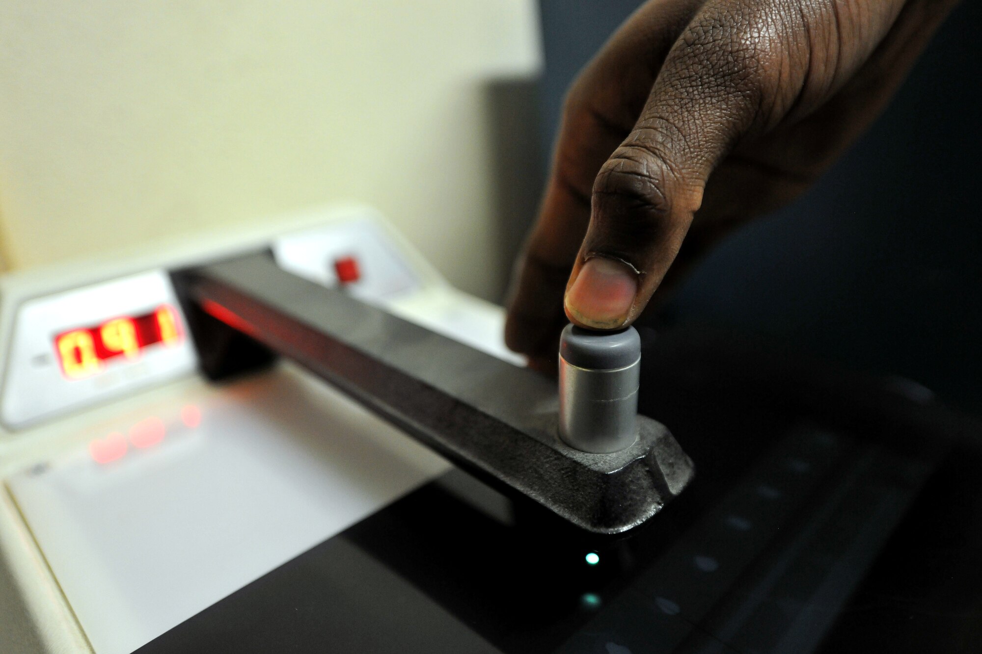 Staff Sgt. D'Shawn Jemmott, 455th Expeditionary Maintenance Squadron Non-Destructive Inspection lab NCOIC, checks x-ray film density at Bagram Airfield, Afghanistan, Jan. 21, 2013. The x-ray film is used to see beneath the surface of aircraft parts to find any cracks or defects.  (U.S. Air Force photo/Senior Airman Chris Willis)
