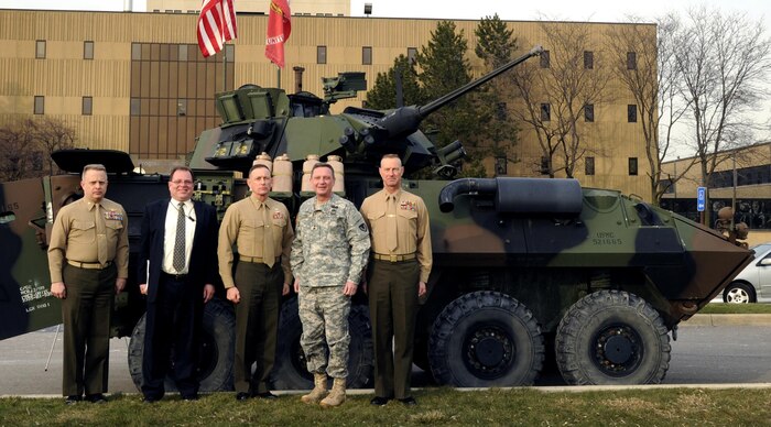 Brigadier General Frank Kelley, Commander, Marine Corps Systems Command (center) visited Light Armored Vehicle and Robotic Systems sites Jan. 15 in Warren, Mich. Also pictured from left are Colonel Mark Brinkman, Program Manager LAV; Michael Viggato, Deputy to the Commander, U.S. Army TACOM Life Cycle Management Command; Army Major General Michael Terry, Commanding General, USATACOM LCMC; and Chief Warrant Officer 5 James Steiner, PM LAV. (PM LAV photo)