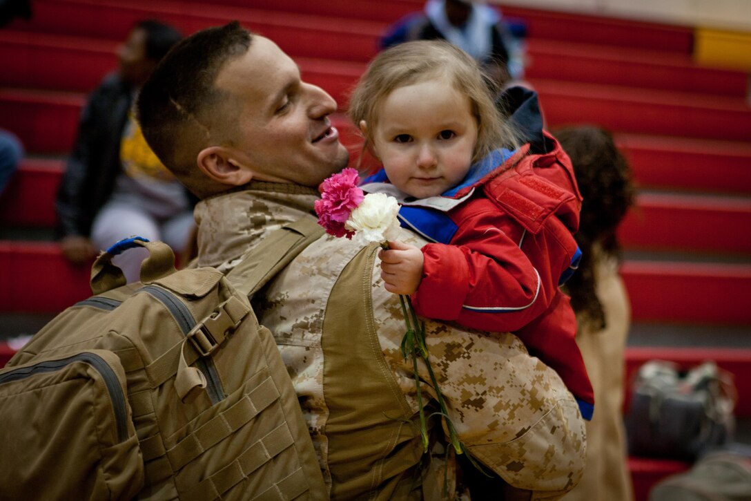 MARINE CORPS BASE CAMP LEJEUNE, N.C. - Cpl. Joshua Talaveralittle, a tank commander with Bravo Company, 2nd Tank Battalion, 2nd Marine Division, hugs his daughter at the company homecoming, Jan. 25, 2013.  The company, deployed to Shir Ghazi, Helmand province, Afghanistan, provided mounted security and support for Regimental Combat Team 7. (U.S. Marine Corps photo by Cpl. Jeff Drew
