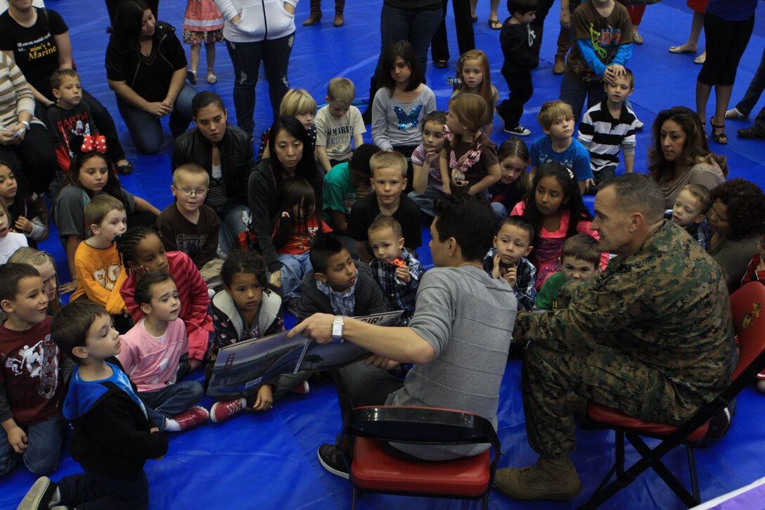 Brig. Gen. Vincent A. Coglianese, the base commanding general and regional authority for five Marine Corps installations in the Southwestern United States, and Disney Channel’s “Shake it Up” star Adam Irigoyen read to an audience of military children and parents during the Books on Bases event hosted by Blue Star Familes and sponsored by Disney here Jan. 26. Books on Bases provided free, age appropriate books to military families to promote the importance of reading.