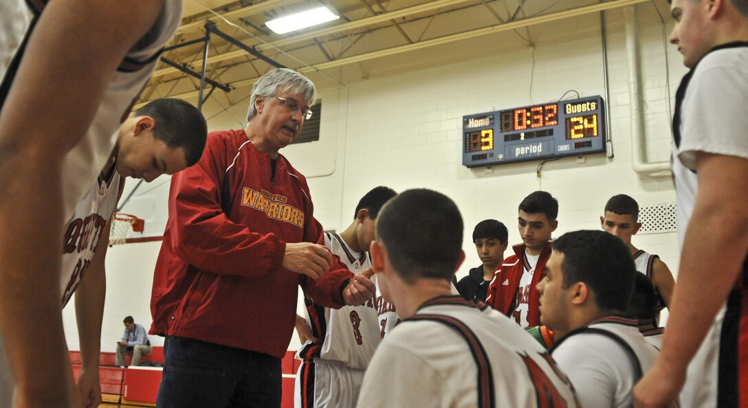 Eddie Cottrell, head coach, Quantico Middle/High School Warriors Boys’ Basketball Varsity Team, talks to his team about turning things around during a home game against the Tandem Friends School Badgers on Jan. 25. The Badgers went on a 15-0 run in the first quarter.