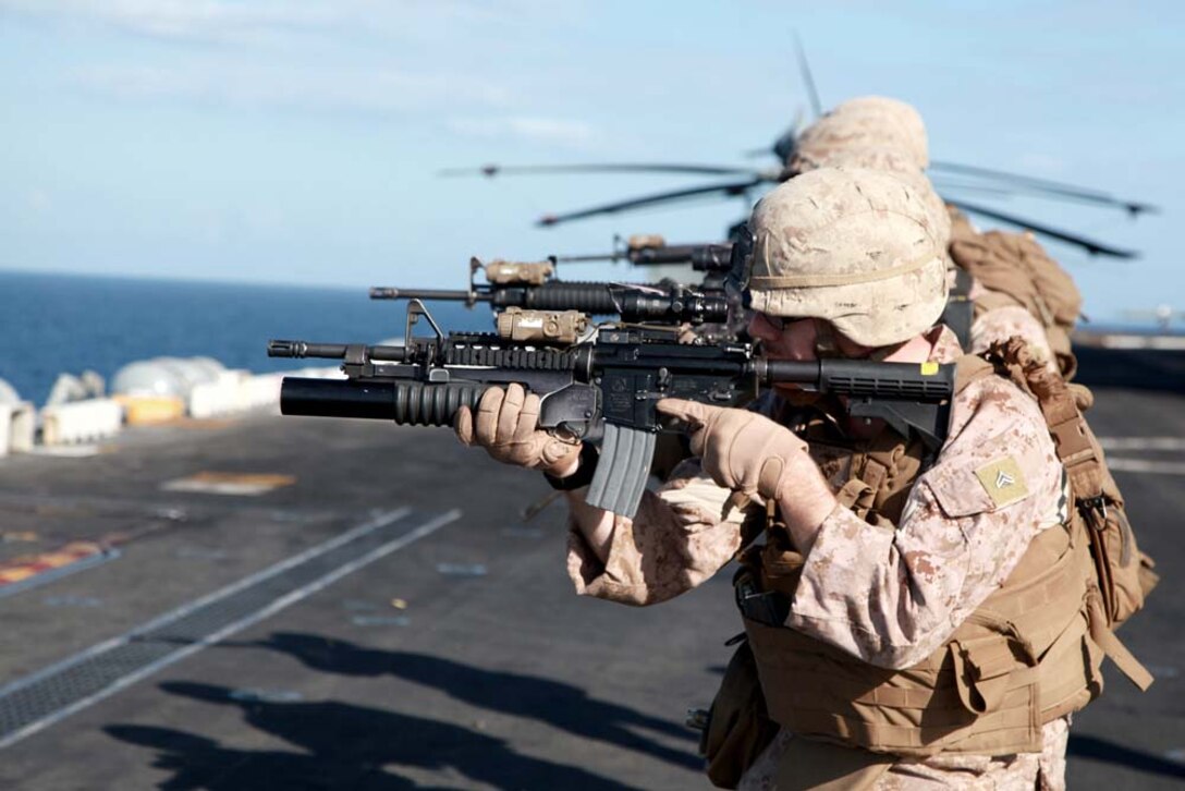 Marines with Kilo Company, Battalion Landing Team 3/5, 15th Marine Expeditionary Unit, fire at their targets on the flight deck of the USS Peleliu, Jan. 22. Kilo Company is one of three rifle companies in BLT 3/5, the 15th MEU's ground combat element. The 15th MEU is deployed as part of the Peleliu Amphibious Ready Group as a U.S. Central Command theater reserve force, providing support for maritime security operations and theater security cooperation efforts in the U.S. 5th Fleet area of responsibility. (U.S. Marine Corps photo by Cpl. John Robbart III)