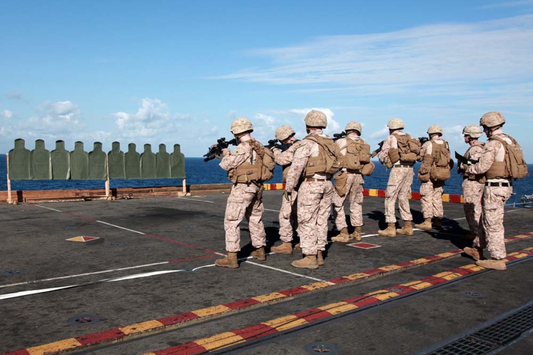 Marines with Kilo Company, Battalion Landing Team 3/5, 15th Marine Expeditionary Unit, fire at their targets on the flight deck of the USS Peleliu, Jan. 22. Kilo Company is one of three rifle companies in BLT 3/5, the 15th MEU's ground combat element. The 15th MEU is deployed as part of the Peleliu Amphibious Ready Group as a U.S. Central Command theater reserve force, providing support for maritime security operations and theater security cooperation efforts in the U.S. 5th Fleet area of responsibility. (U.S. Marine Corps photo by Cpl. John Robbart III)