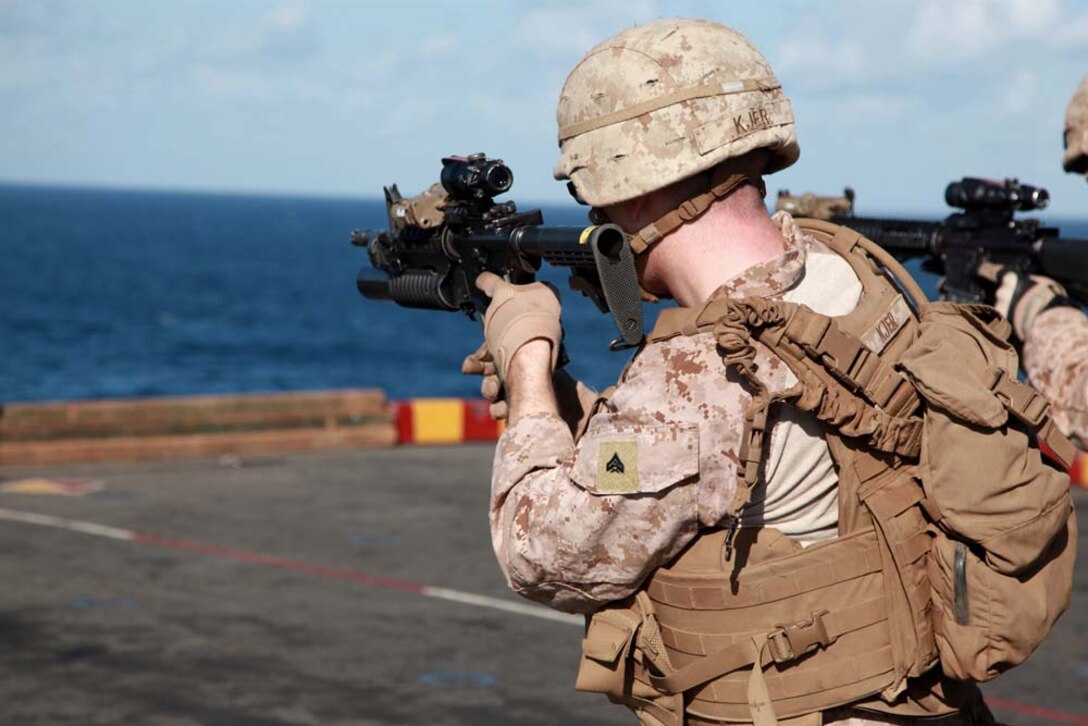 Corporal Kyle P. Kjer, rifleman, 3rd Platoon, Kilo Company, Battalion Landing Team 3/5, 15th Marine Expeditionary Unit, changes his magazine during a range held on the flight deck of the USS Peleliu, Jan. 22. Kilo Company is one of three rifle companies in BLT 3/5, the 15th MEU's ground combat element. The 15th MEU is deployed as part of the Peleliu Amphibious Ready Group as a U.S. Central Command theater reserve force, providing support for maritime security operations and theater security cooperation efforts in the U.S. 5th Fleet area of responsibility. Kjer, 23, is from Lake Tahoe, Nev. (U.S. Marine Corps photo by Cpl. John Robbart III)