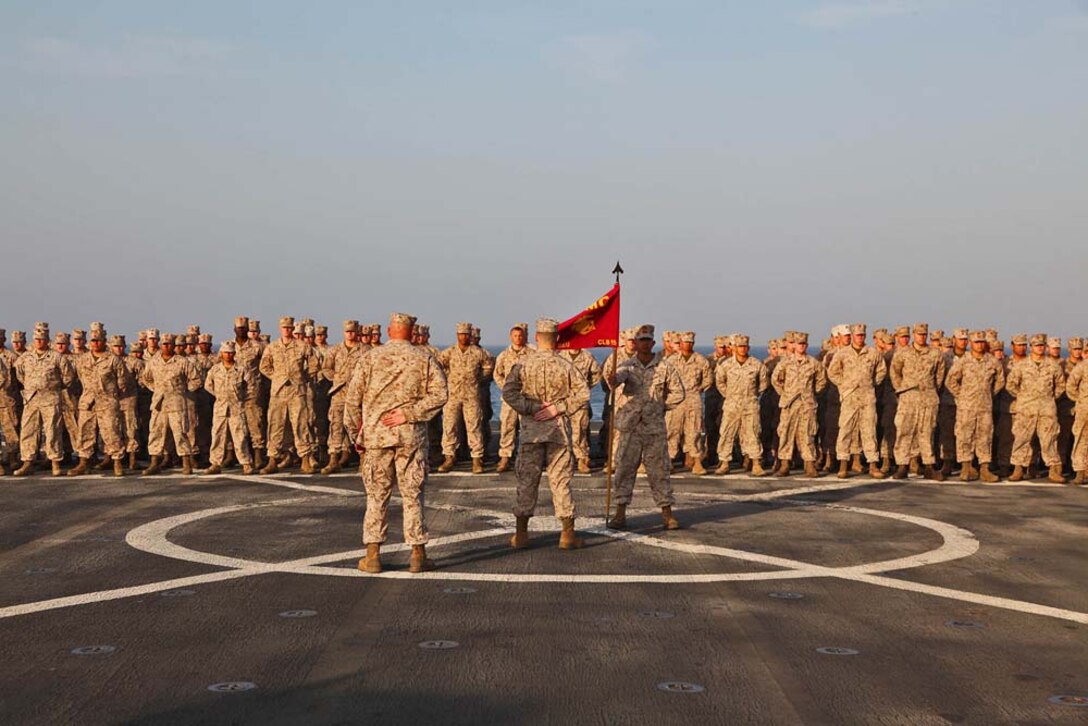 First Sgt. Bradley G. Simmons, Sergeant Major, Combat Logistics Battalion 15, 15th Marine Expeditionary Unit, stands at parade rest in front of his Marines after being presented the Bronze Star with Combat Distinguishing Device, aboard the USS Rushmore, Jan. 25. Simmons, 34, is a native of Liberal, KS. The 15th MEU is deployed as part of the Peleliu Amphibious Ready Group as a U.S. Central Command theater reserve force, providing support for maritime security operations and theater security cooperation efforts in the U.S. 5th Fleet area of responsibility. (U.S. Marine Corps photo by Cpl. Timothy R. Childers)