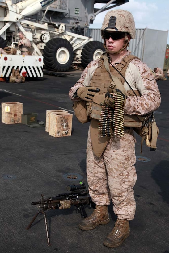 Lance Cpl. Caleb C. Wilkinson, a mortarman with 81mm Mortars/Tactical Recovery of Aircraft and Personnel Platoon, Weapons Company, Battalion Landing Team 3/5, 15th Marine Expeditionary Unit, waits to approach the firing line with a squad automatic weapon during a range on the flight deck of the USS Peleliu, Jan. 25. The 15th MEU is deployed as part of the Peleliu Amphibious Ready Group as a U.S. Central Command theater reserve force, providing support for maritime security operations and theater security cooperation efforts in the U.S. 5th Fleet area of responsibility. Wilkinson, 20, is from Detroit. (U.S. Marine Corps photo by Cpl. John Robbart III)