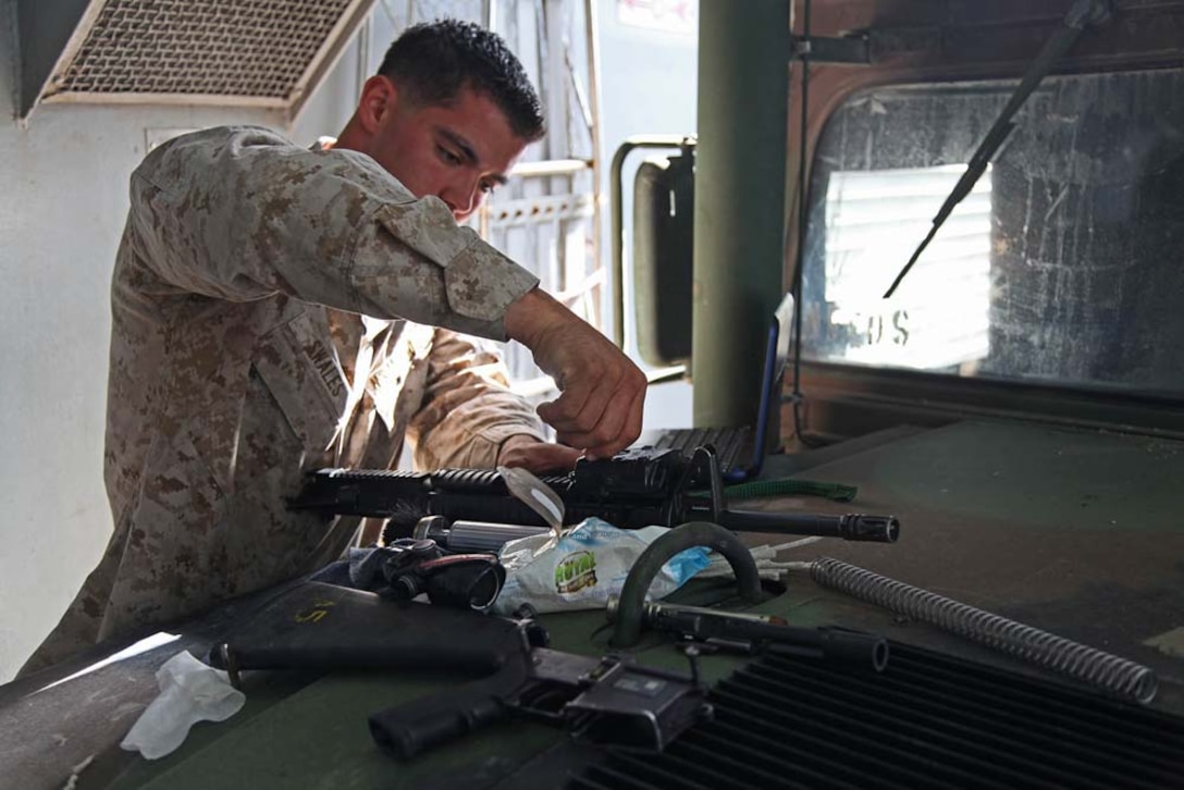 Corporal Anthony L. Swales, cannoneer, Bravo Battery, Battalion Landing Team 3/5, 15th Marine Expeditionary Unit, cleans his M16A4 service rifle aboard the USS Rushmore, Jan. 20. The 15th MEU is deployed as part of the Peleliu Amphibious Ready Group as a U.S. Central Command theater reserve force, providing support for maritime security operations and theater security cooperation efforts in the U.S. 5th Fleet area of responsibility. (U.S. Marine Corps photo by Cpl. Timothy R. Childers)