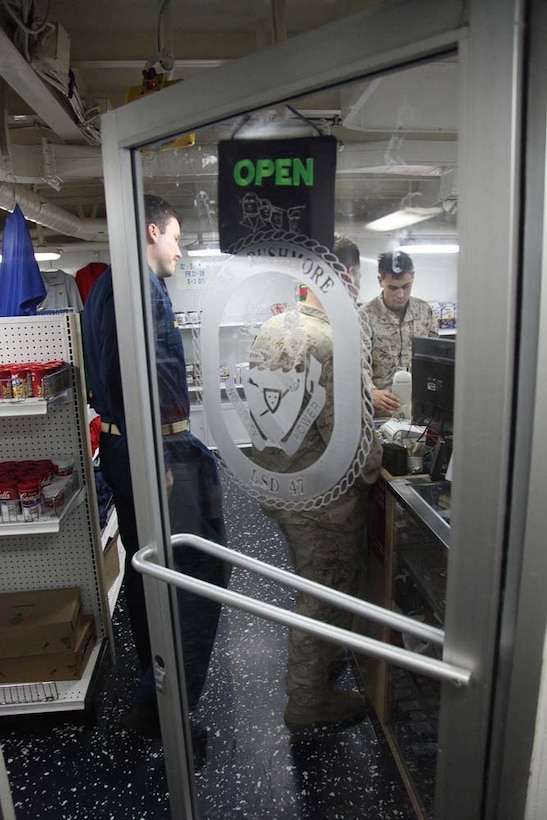 Marines and sailors shop in the ship store aboard the USS Rushmore, Jan. 20. The 15th Marine Expeditionary Unit is deployed as part of the Peleliu Amphibious Ready Group as a U.S. Central Command theater reserve force, providing support for maritime security operations and theater security cooperation efforts in the U.S. 5th Fleet area of responsibility. (U.S. Marine Corps photo by Cpl. Timothy R. Childers)