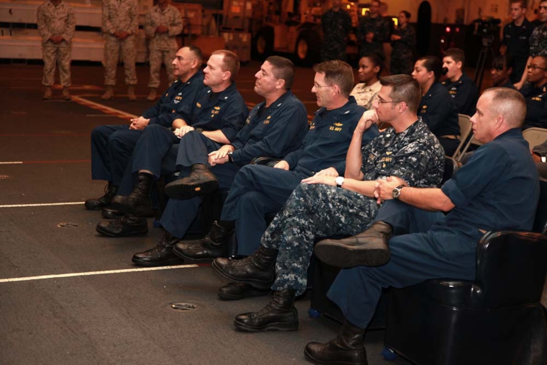 Senior leaders of the Peleliu Amphibious Ready Group listen to speeches and songs during a ceremony held to honor Martin Luther King Day in the hangar bay of the USS Peleliu, Jan. 20. The 15th MEU is deployed as part of the Peleliu Amphibious Ready Group as a U.S. Central Command theater reserve force, providing support for maritime security operations and theater security cooperation efforts in the U.S. 5th Fleet area of responsibility. (U.S. Marine Corps photo by Cpl. John Robbart III)