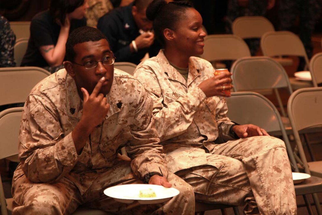 Sergeant Damaino D. Chapman, postal chief, and Cpl. Whitney C. Murray, tactical logistics watch clerk, both with the 15th Marine Expeditionary Unit, attend a celebration held in honor of Martin Luther King Day in the hangar bay of the USS Peleliu, Jan. 20. The 15th MEU is deployed as part of the Peleliu Amphibious Ready Group as a U.S. Central Command theater reserve force, providing support for maritime security operations and theater security cooperation efforts in the U.S. 5th Fleet area of responsibility. Chapman, 28, is from Smithfield, Va., and Murray, 23, is from Pine Bluff, Ark. (U.S. Marine Corps photo by Cpl. John Robbart III)