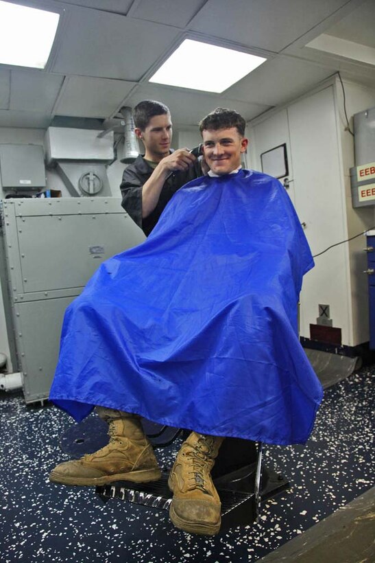Lance Cpl. Anthony J. Mauss, machine-gunner, Combined Anti-Armor Team 1, Weapons Company, Battalion Landing Team 3/5, 15th Marine Expeditionary Unit, gives a haircut to Lance Cpl. Eric D. Wise, a machine-gunner in the same team, aboard the USS Rushmore, Jan. 22. The 15th MEU is deployed as part of the Peleliu Amphibious Ready Group as a U.S. Central Command theater reserve force, providing support for maritime security operations and theater security cooperation efforts in the U.S. 5th Fleet area of responsibility. Mauss, 19, is from Springville, Utah, and Wise, 20, is from Chatham, Ill. (U.S. Marine Corps photo by Cpl. Timothy R. Childers)