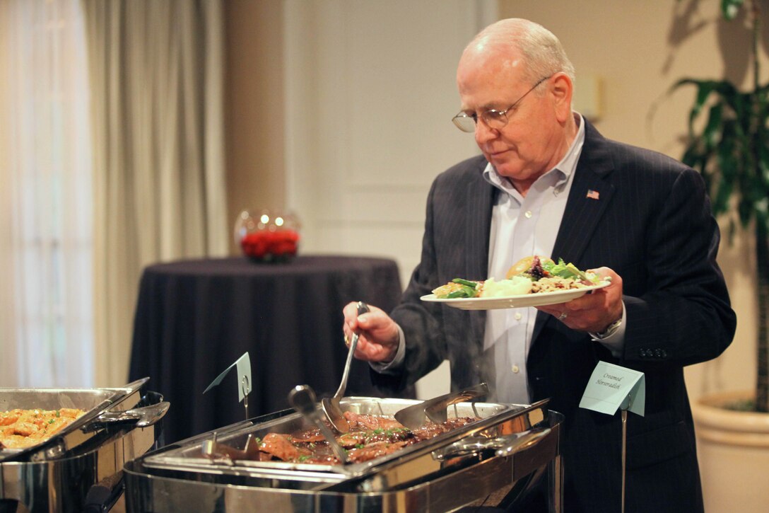 Michael G. Hire, director of the Navy-Marine Corps Relief Society Camp Pendleton, prepares his plate at the beginning of his retirement dinner at the El Camino Country Club in Oceanside, Calif., Jan. 26.