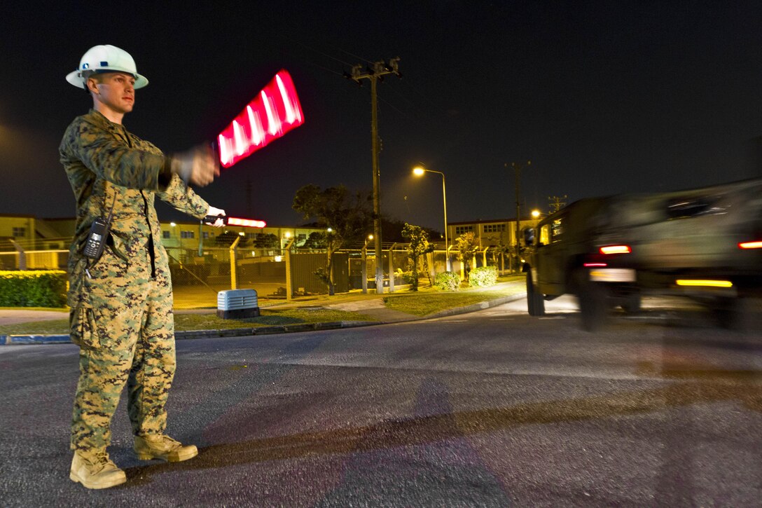 Sergeant Greg P. Spies, the unit movement control coordinator with the 31st Marine Expeditionary Unit and a native of Zalma, Mo., directs the flow of an 81-vehicle convoy en route to the USS Bonhomme Richard here, Jan 24. Moving all the 31st MEU’s tactical vehicles from the Camp Hansen motor pool to the ship docked at White Beach Naval Facility is just one of the many things the MEU Marines must conduct when getting ready for their deployment. “Our job is to plan, coordinate and execute the movement of the 31st MEU personnel and equipment aboard ship, in the field and in garrison,” said Spies. “Embarking for this deployment involves moving over 150 vehicles, 1,700 personnel and 530 short tons of equipment in the span of two weeks.” The 31st MEU is the only continuously forward-deployed MEU and is the Marine Corps’ force in readiness in the Asia-Pacific region.