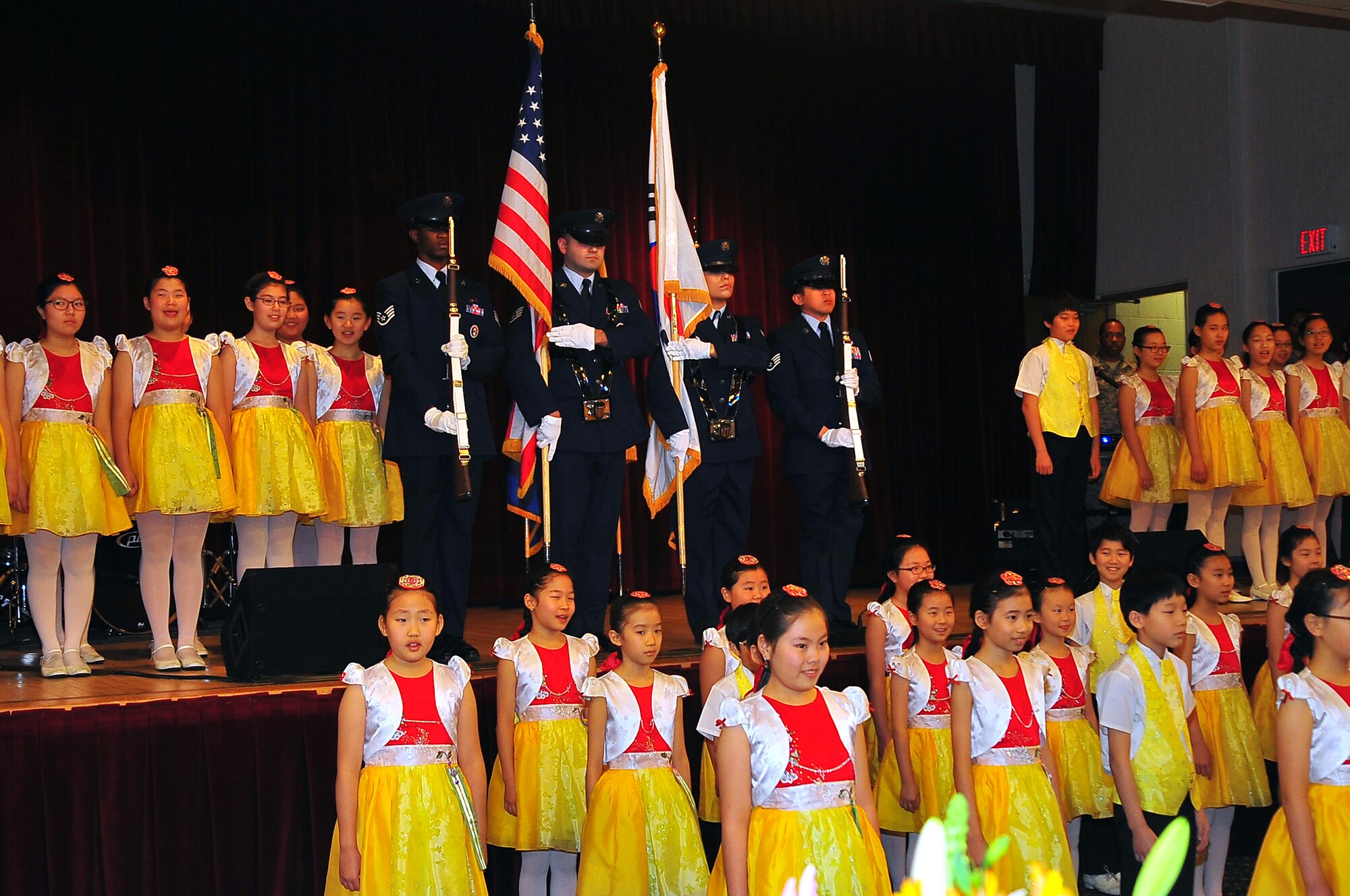 Honor Guard members open for the National Prayer Breakfast, while members from the Far East Broadcasting Company prepare for their performance at the Officers Club on Osan Air Base, Republic of Korea, Jan. 28, 2013.  The Far East Broadcasting Company performed singing and dancing for the event. (U.S. Air Force photo/Staff Sgt. Emerson Nuñez)
