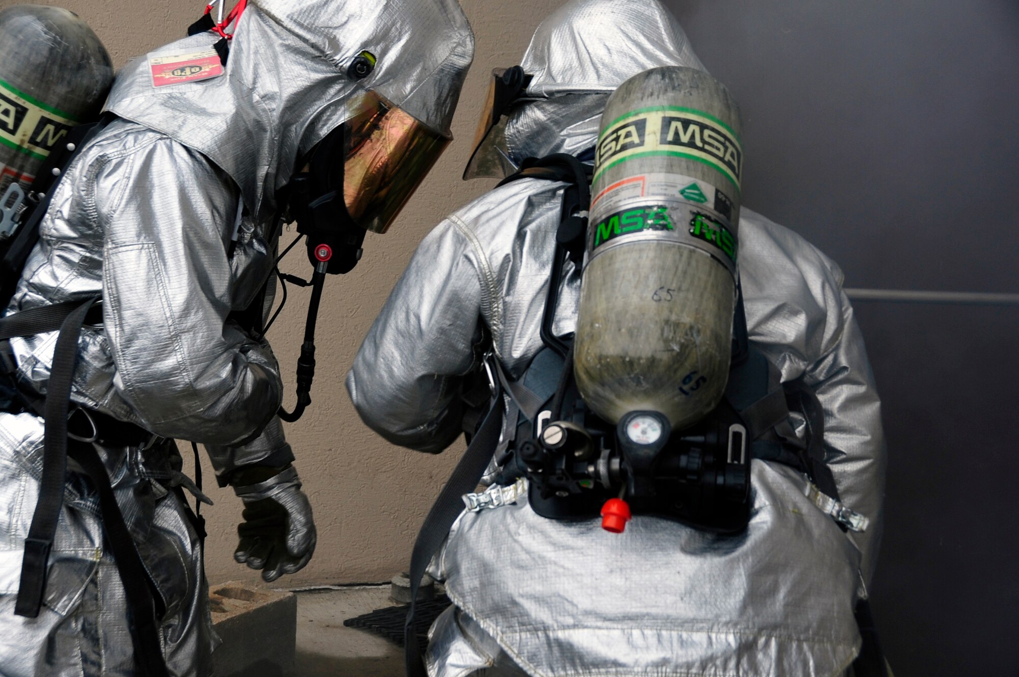 Staff Sgt. Terrell Thomas, left, and Staff Sgt. Travis Barrett, 51st Civil Engineer Squadron fire services lead firefighters, prepare to enter a smoky building while responding to a fire emergency exercise at Osan Air Base, Republic of Korea, Jan. 24, 2012. The exercise scenario was a trash fire emergency. (U.S. Air Force photo/Airman 1st Class Alexis Siekert)