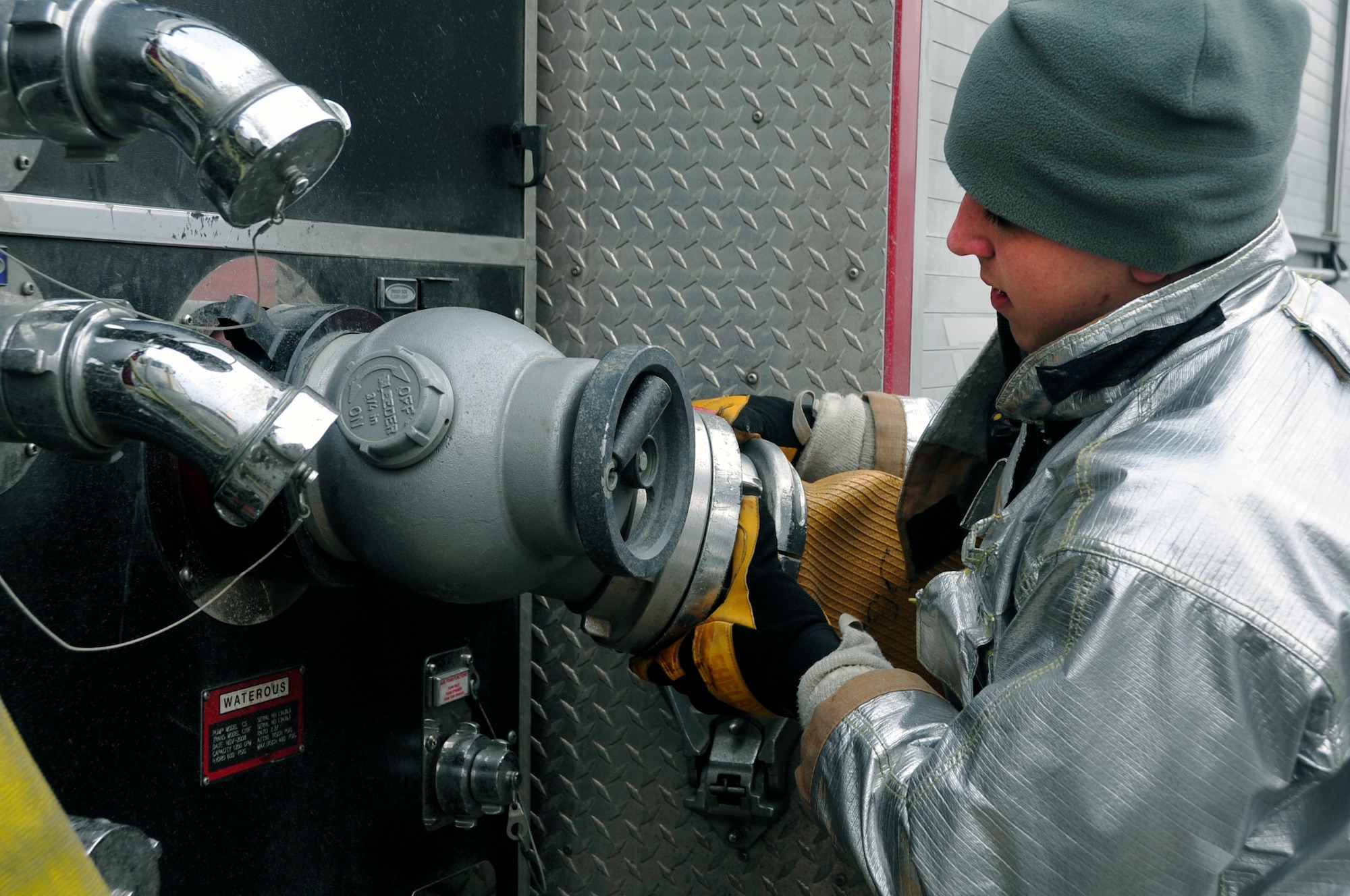 Airman 1st Class Frank Boniello, 51st Civil Engineer Squadron fire services driver operator, establishes a water source to a hydrant while responding to a fire emergency exercise at Osan Air Base, Republic of Korea, Jan. 24, 2012. The team was inspected on their ability to respond to a fire emergency. (U.S. Air Force photo/Airman 1st Class Alexis Siekert)