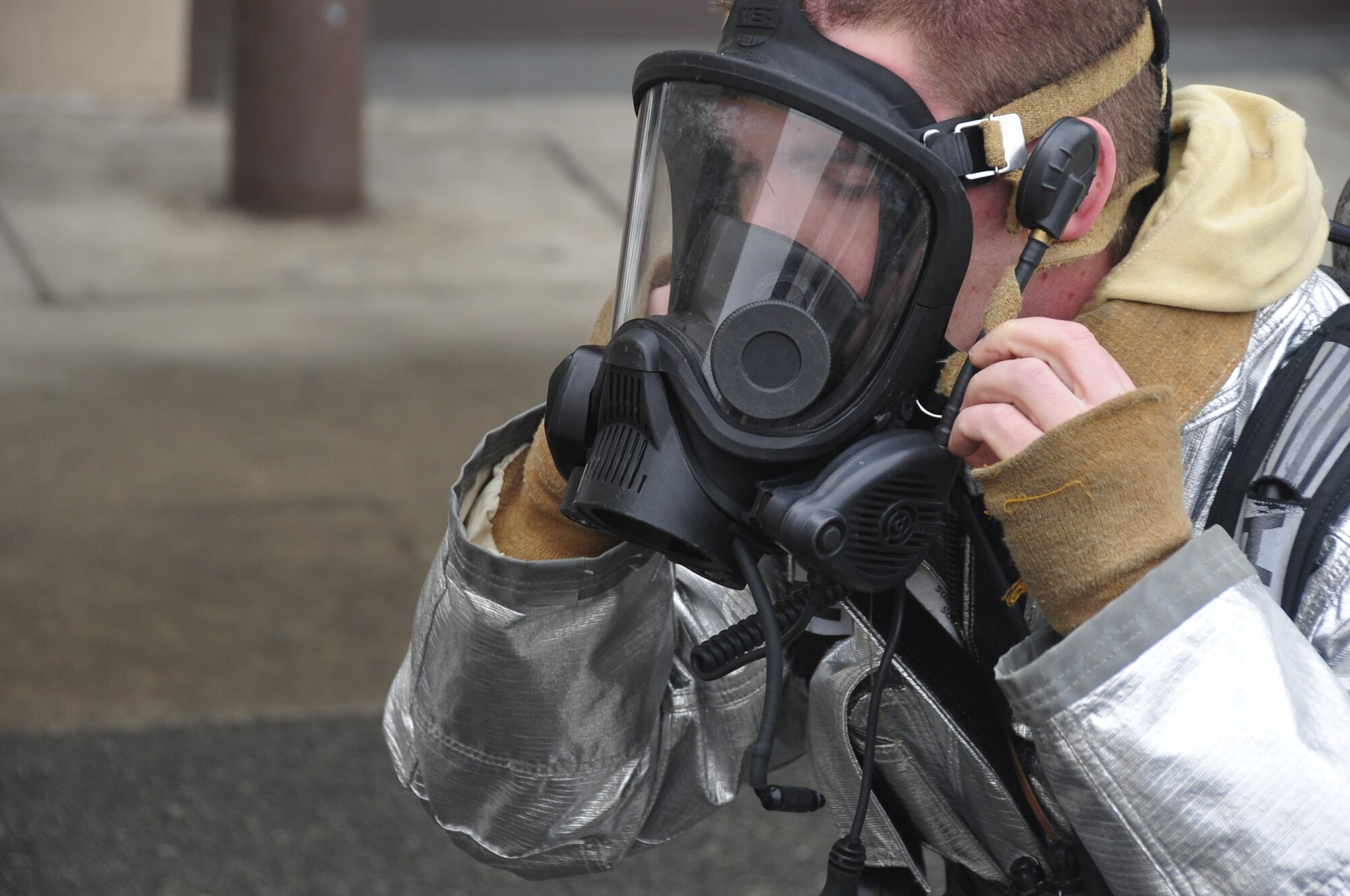 Staff Sgt. Travis Barrett, 51st Civil Engineer Squadron fire services lead firefighter, dons his gear while responding to a fire emergency exercise at Osan Air Base, Republic of Korea, Jan. 24, 2012. Firefighters wear more than 80 lbs. of gear when responding to emergencies. (U.S. Air Force photo/Airman 1st Class Alexis Siekert)Staff Sgt. Travis Barrett, 51st Civil Engineer Squadron fire services lead firefighter, dons his gear while responding to a fire emergency exercise at Osan Air Base, Republic of Korea, Jan. 24, 2012. Firefighters wear more than 80 lbs. of gear when responding to emergencies. (U.S. Air Force photo/Airman 1st Class Alexis Siekert)