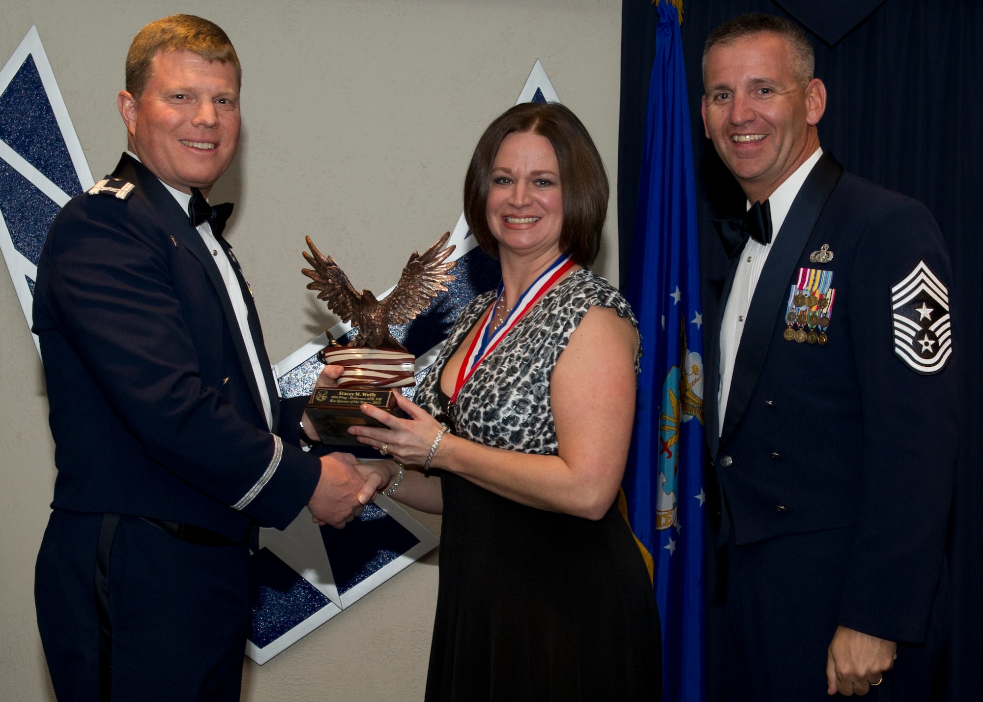 Colonel Andy Croft, 49th Wing commander, presents the 49th WG’s 2012 Key Spouse of the Year Award to Stacey Wolfe at the Annual Awards Banquet Jan. 25 at the Holloman Air Force Base, N.M., Enlisted Club. The other nominee for the award was Nichole, Krebs. (U.S. Air Force photo by Senior Airman Siuta B. Ika/ Released)