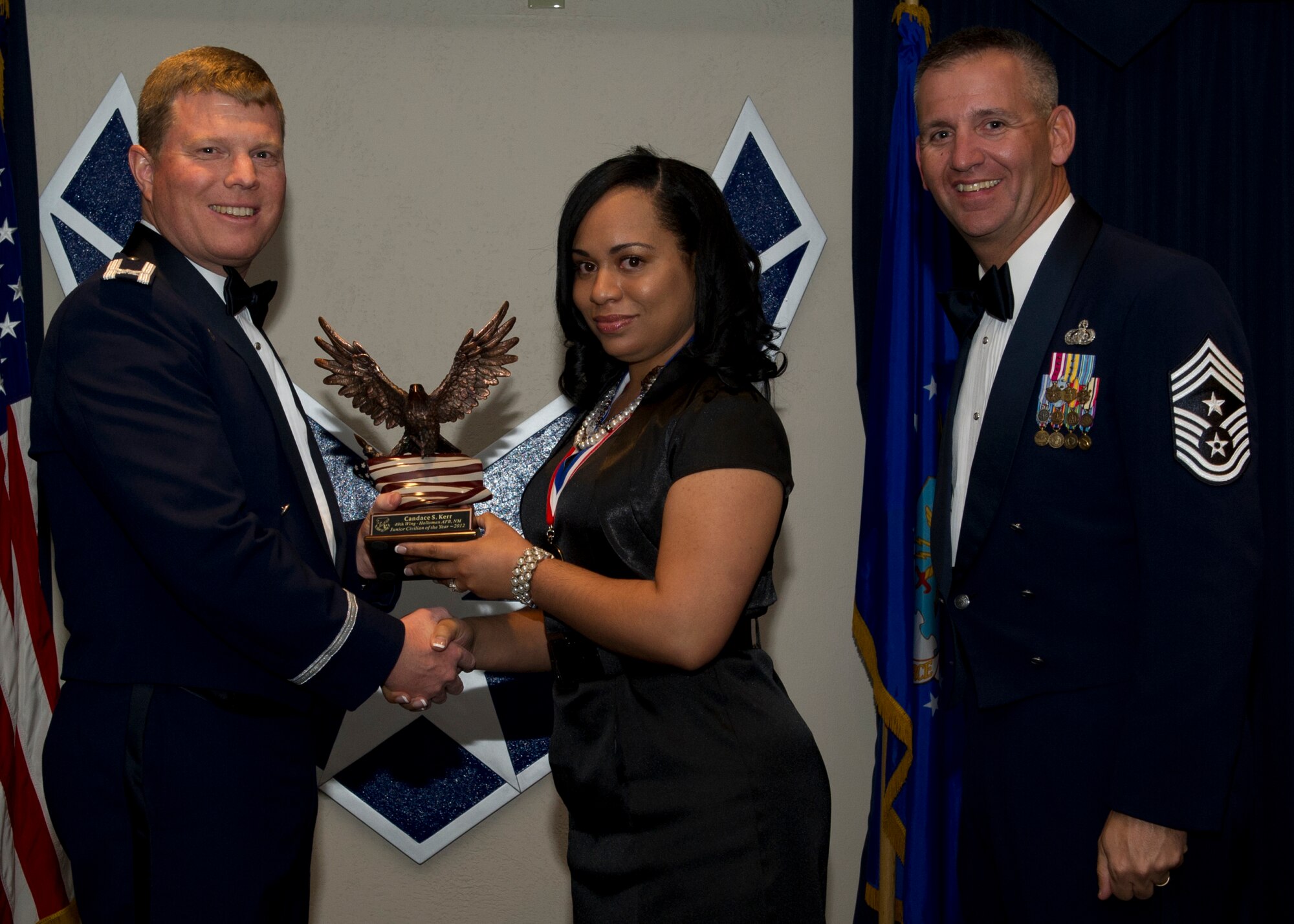 Colonel Andy Croft, 49th Wing commander, presents the 49th WG’s 2012 Junior Civilian of the Year Award to Candace Kerr, 49th Operations Group, at the Annual Awards Banquet Jan. 25 at the Holloman Air Force Base, N.M., Enlisted Club. The other nominees for the award were Shelley Bailey, 49th Maintenance Group, Rachel Weidner, 49th Mission Support Group, Charles Lemley, 49th Wing Staff, and Lorene Groves, 49th Medical Group. (U.S. Air Force photo by Senior Airman Siuta B. Ika/ Released)