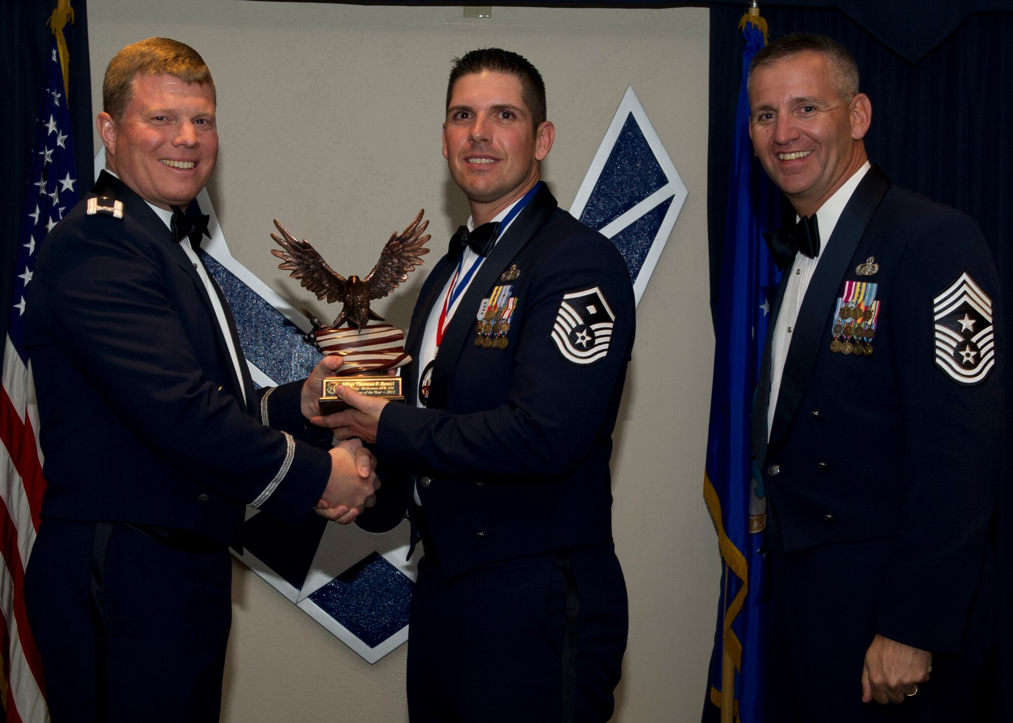 Colonel Andy Croft, 49th Wing commander, presents the 49th WG’s 2012 First Sergeant of the Year Award to Master Sgt. Thomas Henzl, 49th Operations Group, at the Annual Awards Banquet Jan. 25 at the Holloman Air Force Base, N.M., Enlisted Club. The other nominees for the award were Master Sgt. Jill Tanner, 49th Maintenance Group, Master Sgt. Tracy Wolfe, 49th Mission Support Group, Master Sgt. Steven Reynolds, 49th Medical Group/49th Wing Staff, and Master Sgt. Michael Cuevas, 49th Materiel Maintenance Group. (U.S. Air Force photo by Senior Airman Siuta B. Ika/ Released)