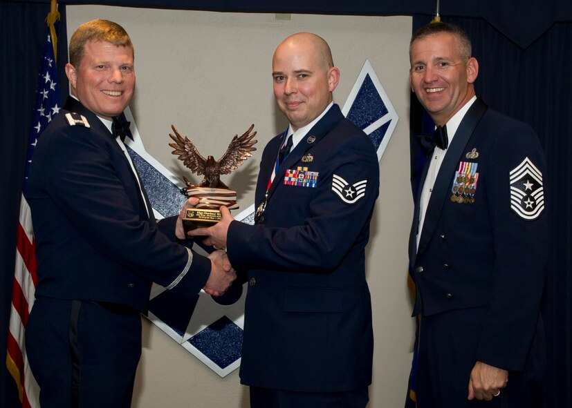 Colonel Andy Croft, 49th Wing commander, presents the 49th WG’s 2012 NCO of the Year Award to Staff Sgt. Charles White, 49th Maintenance Group, at the Annual Awards Banquet Jan. 25 at the Holloman Air Force Base, N.M., Enlisted Club. The other nominees for the award were Tech. Sgt. Jay Galea, 49th Operations Group, Tech. Sgt. Erica Jordan, 49th Mission Support Group, Tech. Sgt. Manuel Avelarizalde, 49th Materiel Maintenance Group, Tech. Sgt. Abdalia Smith, 49th Wing Staff, and Tech. Sgt. Petra Nelson, 49th Medical Group. (U.S. Air Force photo by Senior Airman Siuta B. Ika/ Released)