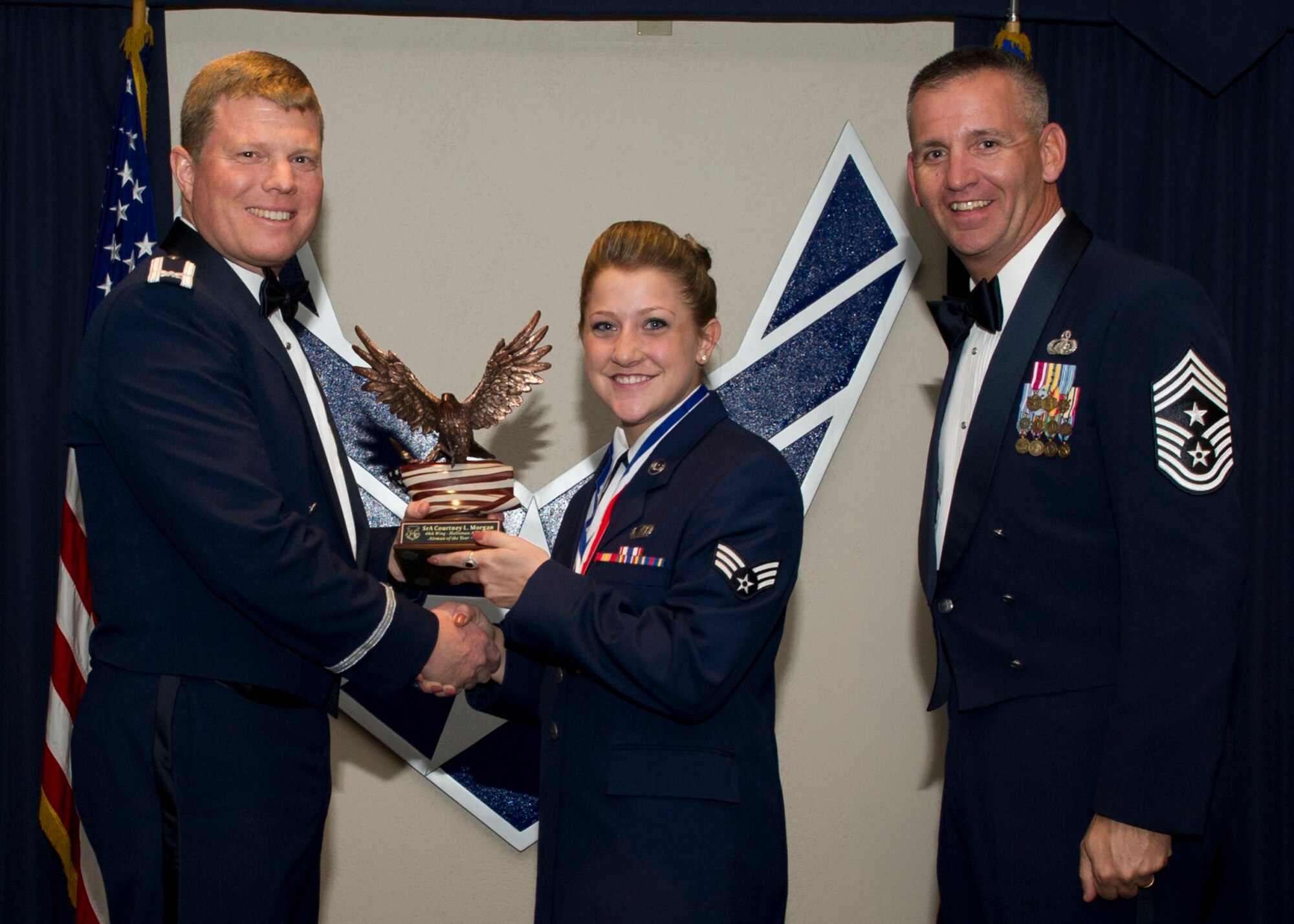 Colonel Andy Croft, 49th Wing commander, presents the 49th WG’s 2012 Airman of the Year Award to Senior Airman Courtney Morgan, 49th WG Staff, at the Annual Awards Banquet Jan. 25 at the Holloman Air Force Base, N.M., Enlisted Club. The other nominees for the award were Staff Sgt. Kyle Causey, 49th Operations Group, Senior Airman Martin Molina, 49th Maintenance Group, Senior Airman Robert Moll, 49th Mission Support Group, Senior Airman Jamie Miller, 49th Medical Group, Senior Airman Derrick Smith, 49th Materiel Maintenance Group. (U.S. Air Force photo by Senior Airman Siuta B. Ika/ Released)