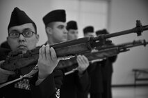 Seven honor guard trainees fire a three-volley rifle salute in a simulated 21-gun salute during their graduation at Fairchild Air Force Base, Wash., Jan. 10, 2013. This honor is given to active-duty members at their funeral.  The three shots signify duty, honor and country. (U.S. Air Force photo illustration by Senior Airman Taylor Curry)
