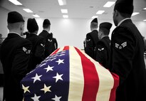 During a demonstration of a mock active-duty funeral, honor guard trainees carry a casket during their graduation at Fairchild Air Force Base, Wash., Jan. 10, 2013. At active-duty funerals, six members of the honor guard carry the casket to the gravestone where they fold the flag then present it to the next-of-kin. (U.S. Air Force photo illustration by Senior Airman Taylor Curry)