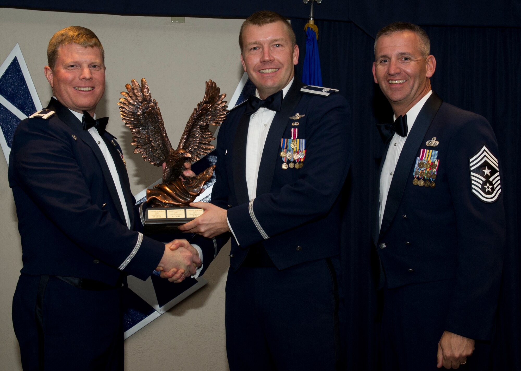 Colonel Andy Croft, 49th Wing commander, presents the 49th WG’s 2012 Large Unit of the Year Award to Lt. Col. Shawn Anger, 7th Fighter Squadron director of operations, at the Annual Awards Banquet Jan. 25 at the Holloman Air Force Base, N.M., Enlisted Club. The other nominees for the award were the 49th Contracting Squadron, 49th Comptroller Squadron, 49th Medical Operations Squadron, and the 49th Maintenance Operations Squadron. (U.S. Air Force photo by Senior Airman Siuta B. Ika/ Released)