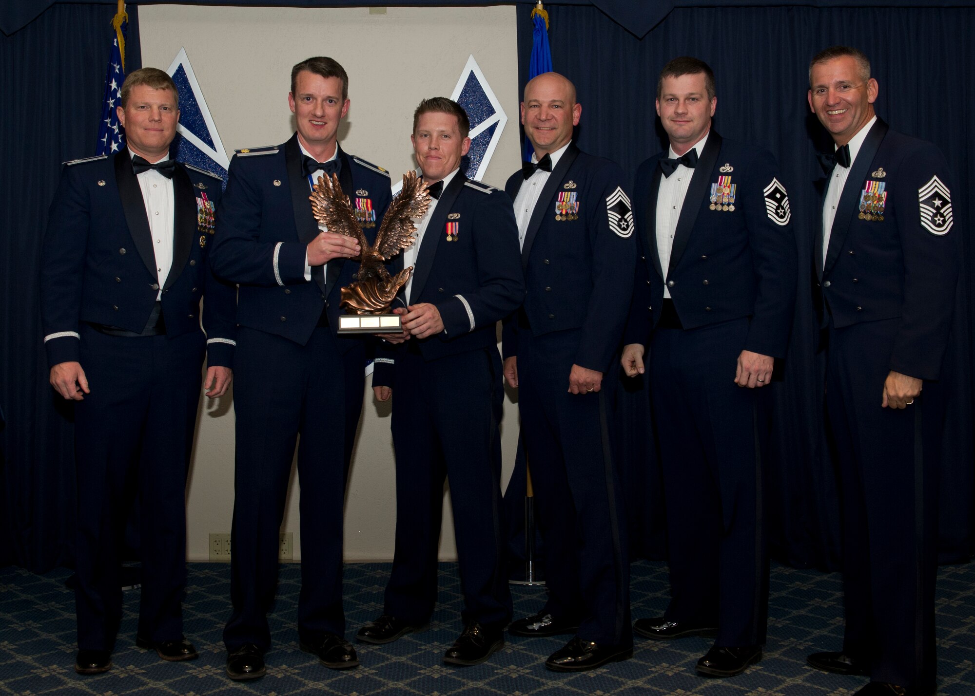 Colonel Andy Croft, 49th Wing commander, presents the 49th WG’s 2012 Large Unit of the Year Award to leadership of the 849th Aircraft Maintenance Squadron at the Annual Awards Banquet Jan. 25 at the Holloman Air Force Base, N.M., Enlisted Club. The other nominees for the award were the 49th Operations Support Squadron, 49th Civil Engineer Squadron, and the 49th Materiel Maintenance Squadron. (U.S. Air Force photo by Senior Airman Siuta B. Ika/ Released)