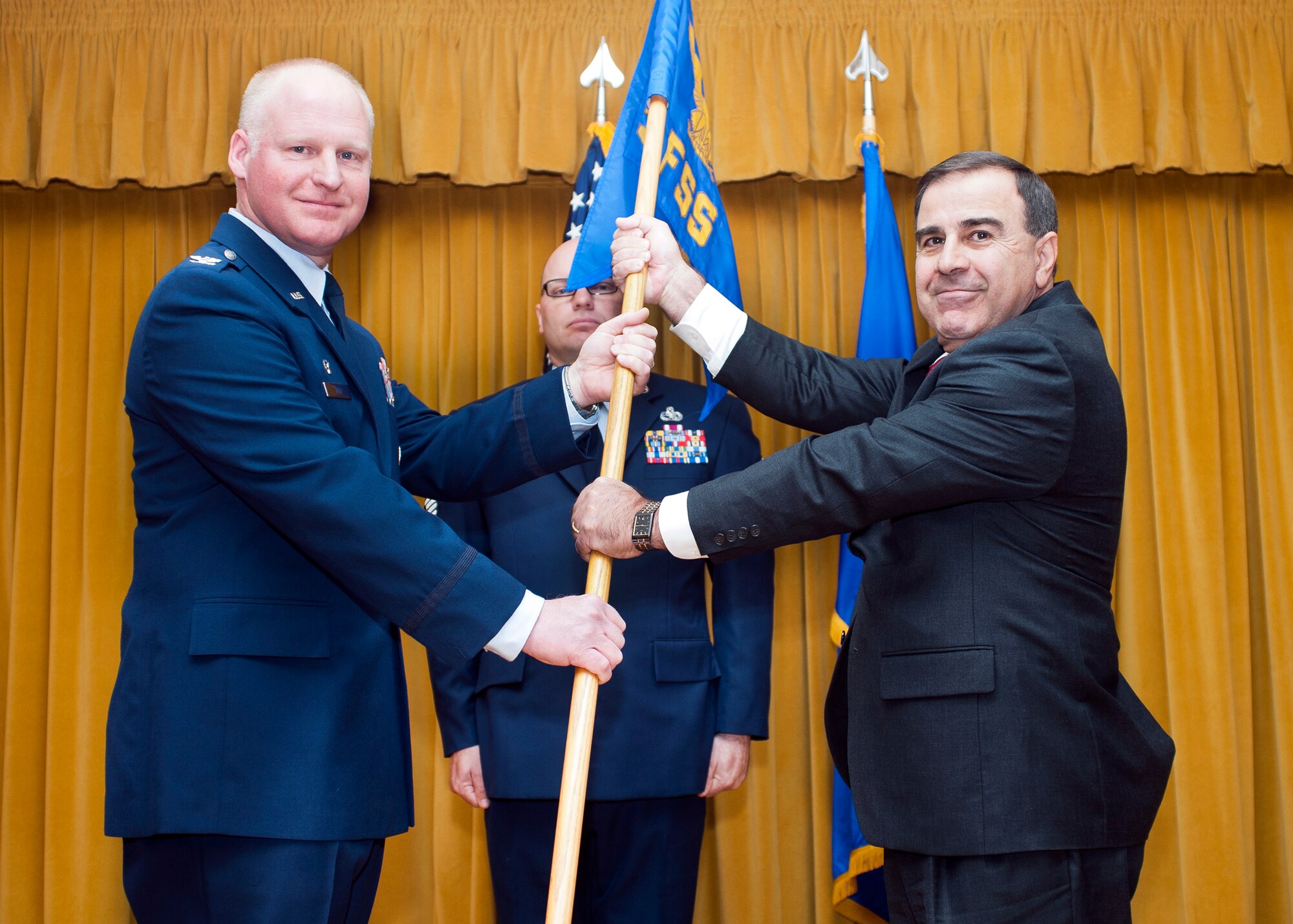 From left: Col. Robert Hoff, 412th Mission Support Group commander, hands the 412th Force Support Squadron to Alexander Kovras during a change of leadership ceremony at Club Muroc Jan. 23. (U.S. Air Force photo by Ethan Wagner)