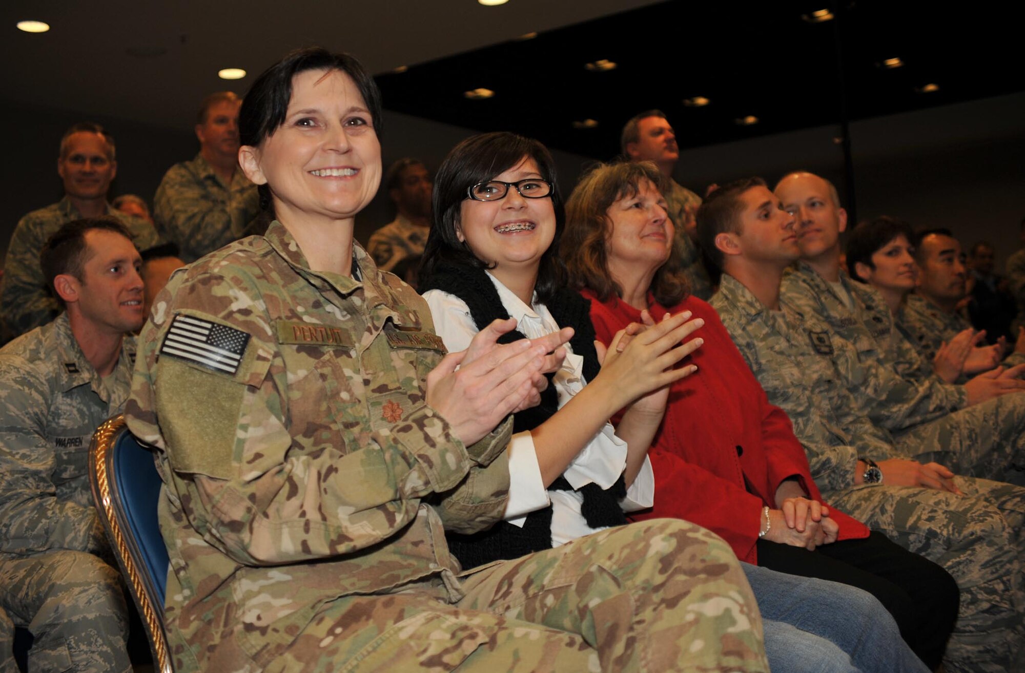 Major Sandra Pertuit (pictured left) is among the returning airmen and their families honored at the Welcome Home Airmen ceremony, Jan. 24.  The airmen returned during the past six months from deployments at locations around the world.  (Photo by Sarah Corrice)