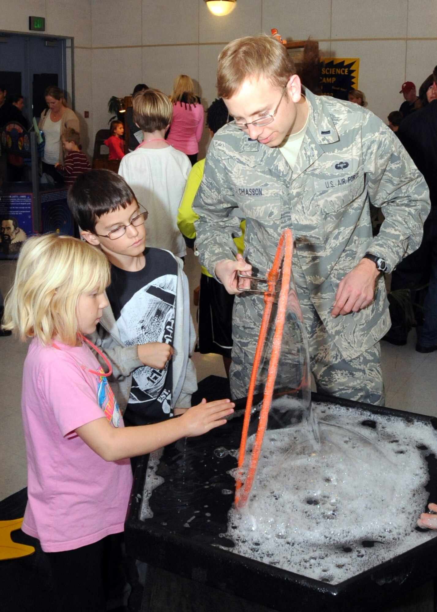 Lt. Thomas Chiasson works with students at a Science, Technology, Engineering and Mathematics (STEM) event held at El Segundo’s Richmond Street School, Jan. 23. Air Force volunteers manned various experiment stations during the event.  (Photo by Jim Gordon)