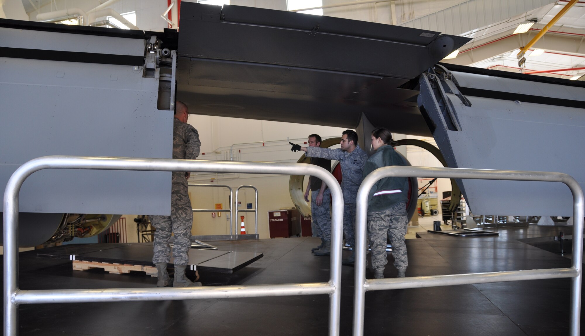 Airman 1st Class Jason Becker, 137th Oklahoma Air National Guard maintenance squadron, points out the distance between the top of the new KC-135 maintenance platforms and the bottom of a KC-135 Stratotanker engine.  Each new platform is about 1,500 square feet and maintenance officials expect them to increase safety and cut down on inspection times.  (Photo by Senior Airman Mark Hybers)  