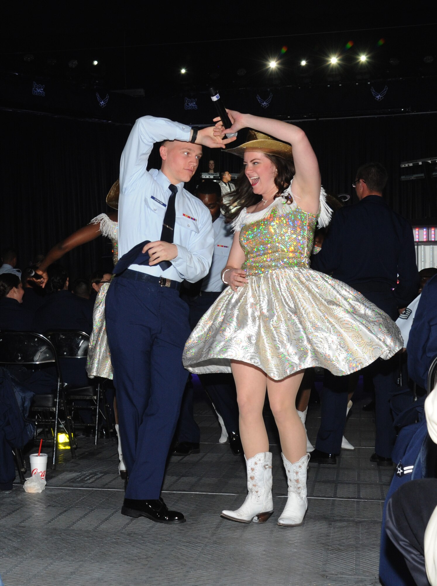 Airman Basic Jarrett Stockton, 334th Training Squadron, dances in the aisle with Capt. Ashley Elmore, Ellsworth AFB, S.D., during a performance by Tops in Blue as part of their 2012 World Tour Jan. 27, 2013, at the Mississippi Coast Coliseum.  Hundreds of Keesler Airmen, families and community members watched and listened as the sequin-studded members of Tops in Blue performed their diverse show.  (U.S. Air Force photo by Kemberly Groue)