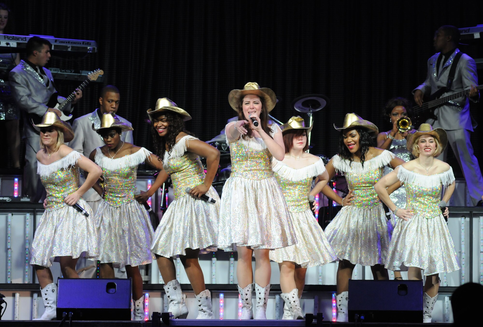 Members of the Tops in Blue 2012 World Tour perform a country song Jan. 27, 2013, at the Mississippi Coast Coliseum.  Hundreds of Keesler Airmen, families and community members watched and listened as the sequin-studded members of Tops in Blue performed their diverse show. According to its website, Tops in Blue began in 1953 and has since performed on film, on national television and at events like the Super Bowl and World’s Fair. This year’s tour takes the group to more than 20 countries with nearly 130 performances. For more information on the team or audition requirements, visit www.topsinblue.com.  (U.S. Air Force photo by Kemberly Groue)