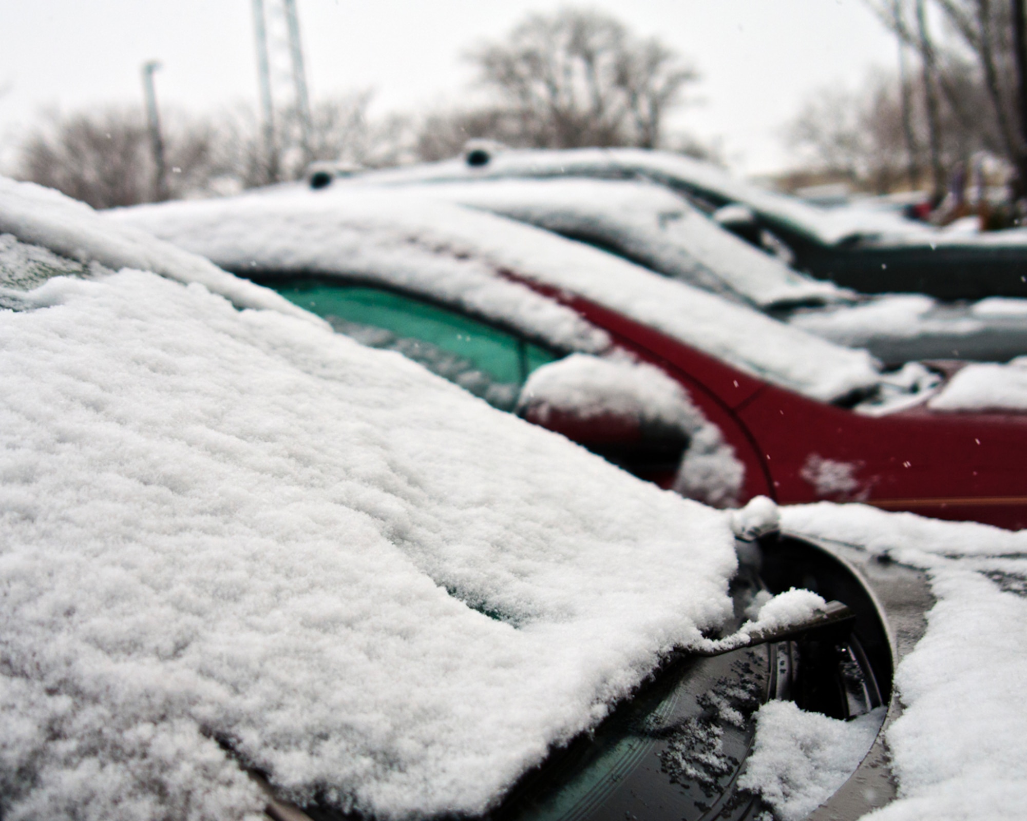 Cars are covered with snow outside a Mountain Home Air Force Base, Idaho, building Jan. 28, 2013. Repairs and maintenance due to winter weather-related damages have already cost the civil engineers 10 percent of their annual budget, said John Bialke, 366th Civil Engineer Squadron deputy commander. (U.S. Air Force photo/Master Sgt. Kevin Wallace/RELEASED)
