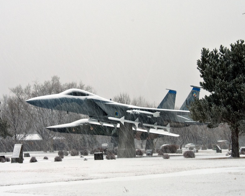 Snow falls on static aircraft on display at Mountain Home Air Force Base, Idaho, Jan. 28, 2013. Repairs and maintenance due to winter weather-related damages have already cost the civil engineers 10 percent of their annual budget, said John Bialke, 366th Civil Engineer Squadron deputy commander. (U.S. Air Force photo/Master Sgt. Kevin Wallace/RELEASED)