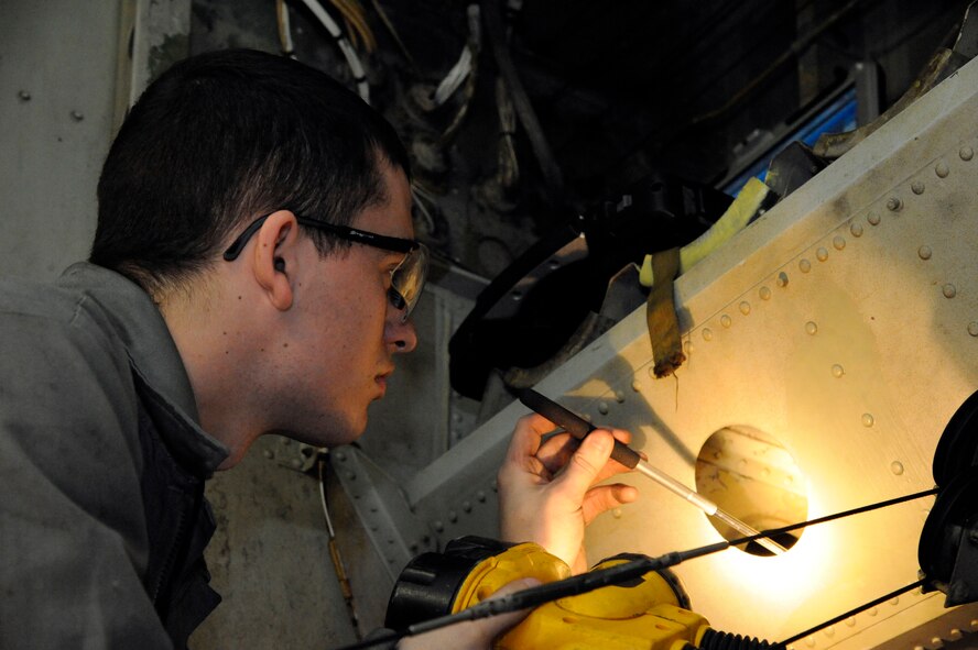 Airman Dylan Fox, 2nd Maintenance Squadron fabrication flight, inspects a B-52H Stratofortress for corrosion during a phase inspection on Barksdale Air Force Base, La., Jan. 28. Corrosion is caused by a variety of factors such as humidity and may cause millions of dollars of damage by reducing structural integrity of the aircraft. (U.S. Air Force photo/Airman 1st Class Andrew Moua)