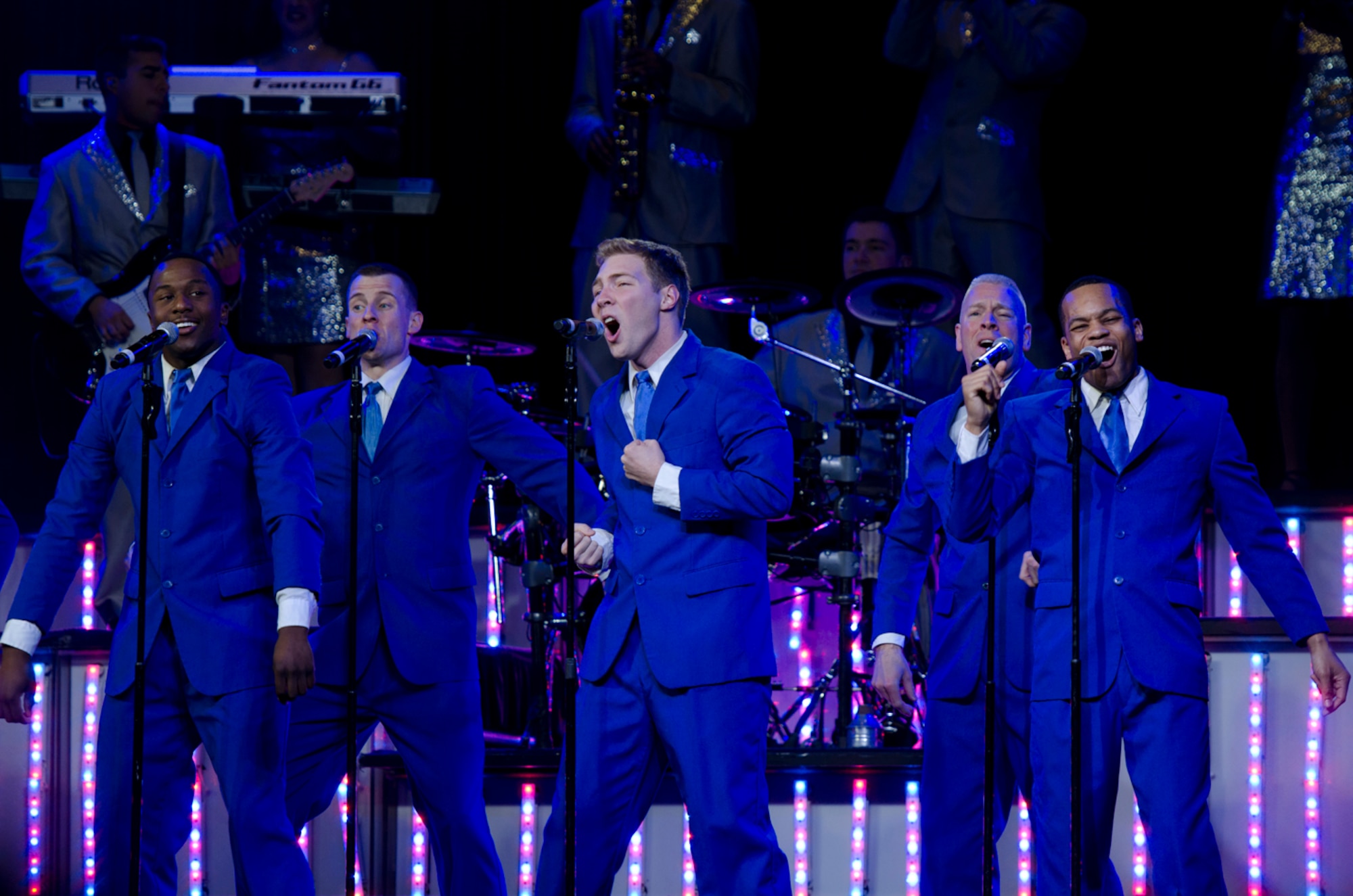 Members of Tops In Blue belt out a tune during a performance at the Freedom Hangar on Hurlburt Field, Fla., Jan. 23, 2013. The tour included songs from several different genres and time periods, ranging from hip-hop to country and choreographed dance.
(U.S. Air Force Photo/ Staff Sgt. John Bainter)
