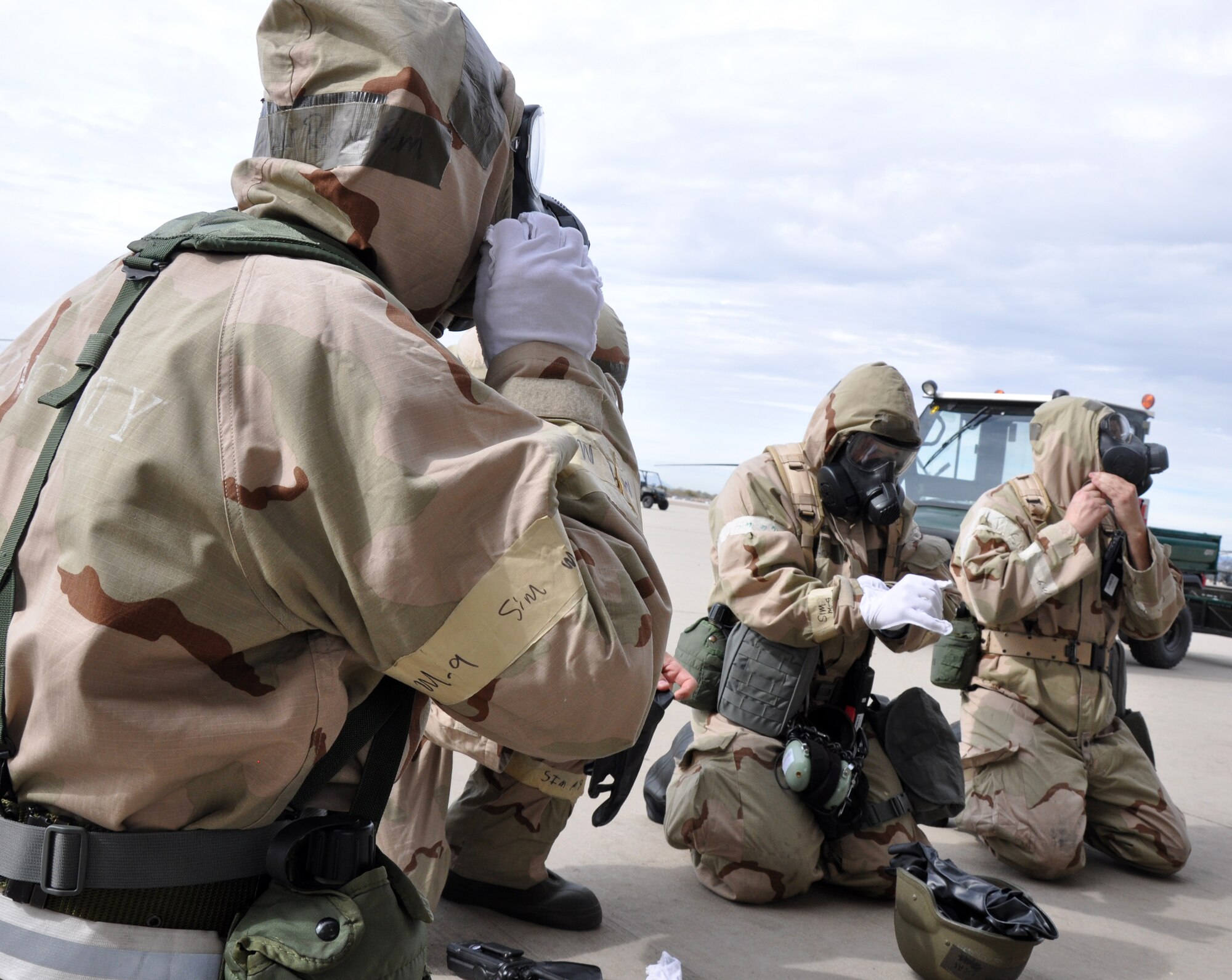 Airmen from the 943rd Maintenance Squadron practice donning chemical protective gear during a Chemical, Biological, Radiological, Nuclear and Explosive defensive training exercise on the flight line at Davis Monthan Air Force Base, Ariz. The 943rd MXS worked on honing their CBRNE skills in preparation for the upcoming Operational Readiness Exercise with the 920th Rescue Wing in February.  (U.S. Air Force Photo/ Master Sgt. Luke Johnson)