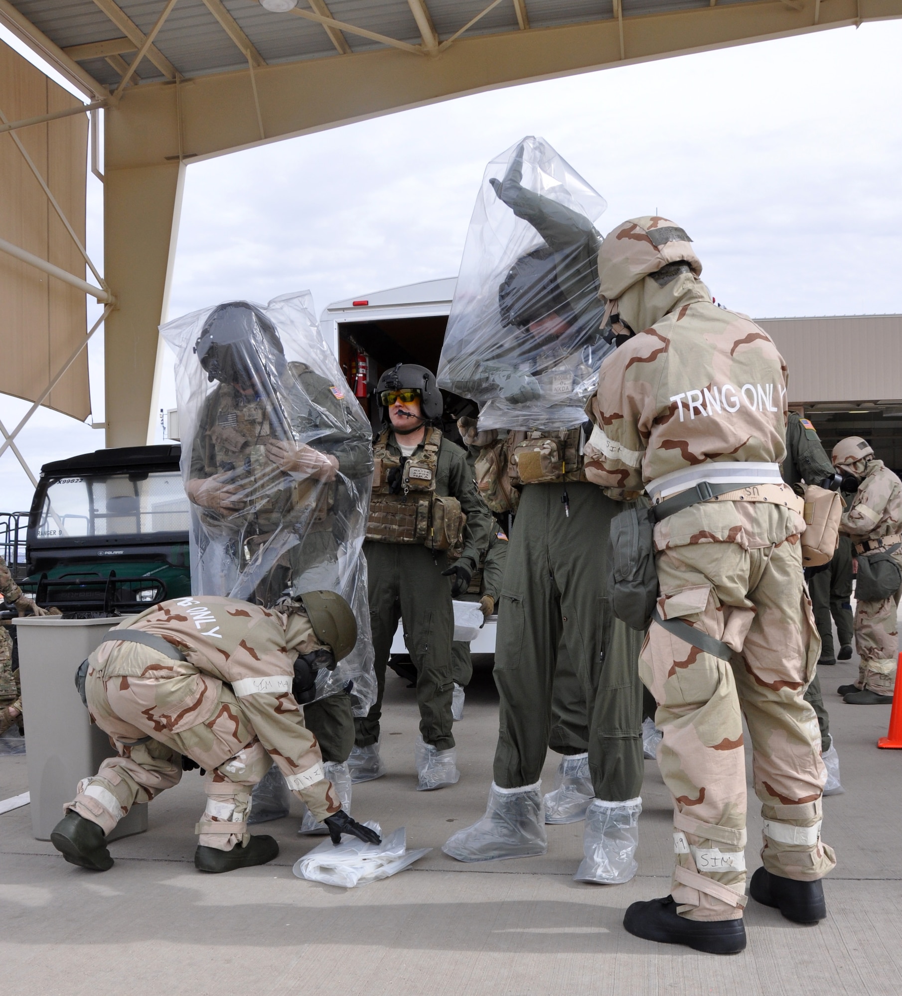 Aircrew flight equipment Airmen from the 943rd Rescue Group practice donning chemical protective gear on aircrew during a Chemical, Biological, Radiological, Nuclear and Explosive defensive training session on the flight line at Davis Monthan Air Force Base, Ariz. Rescue group Airmen were utilizing the training session to prepare for the upcoming Operational Readiness Exercise with the 920th Rescue Wing in February. (U.S. Air Force Photo/ Master Sgt. Luke Johnson)