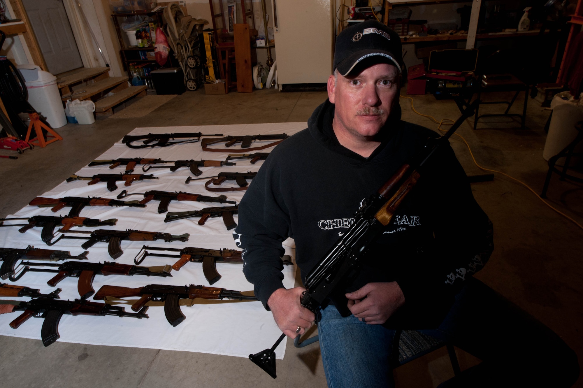 Master Sgt. Monte Ealy, 28th Civil Engineer readiness and emergency management NCO in charge, adds his completed AK- pattern semi-automatic rifle replica to his collection in Rapid City, S.D., Dec. 11, 2012. Ealy explained that there’s a sense of pride and craftsmanship in putting together a loose collection of parts and building a functioning firearm. (U.S. Air Force photo by Airman 1st Class Zachary Hada/Released)