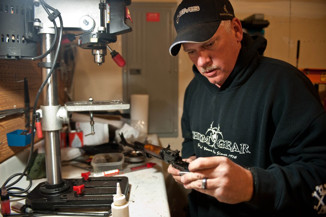 Master Sgt. Monte Ealy, 28th Civil Engineer readiness and emergency management NCO in charge, assembles an AK- pattern semi-automatic rifle replica frame in Rapid City, S.D., Dec. 11, 2012. Ealy, an exercise evaluation team member, ensures exercises are conducted according to directives while on duty, and builds rifles, as a hobby. (U.S. Air Force photo by Airman 1st Class Zachary Hada/Released) 