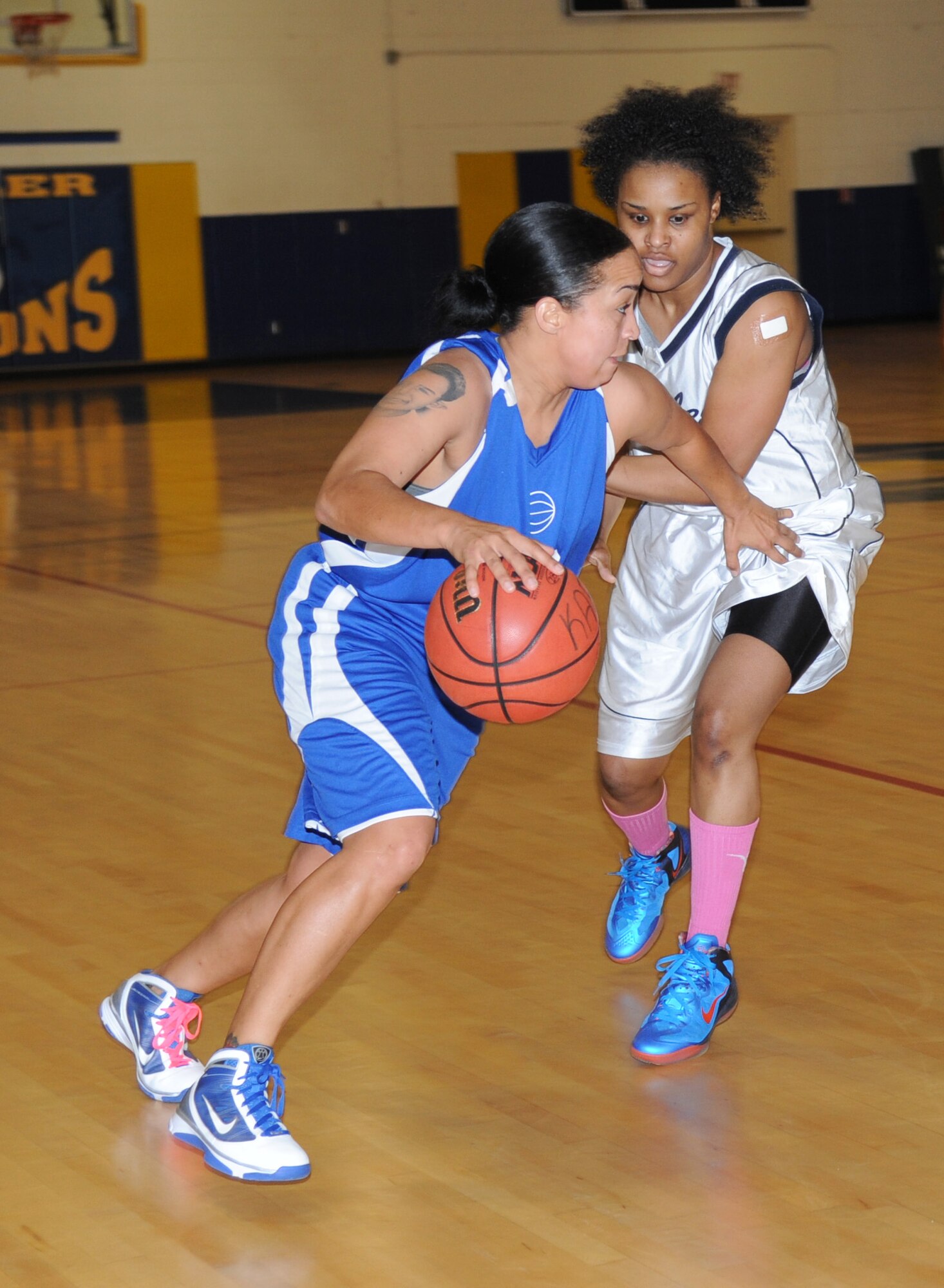 Dameka McClendon, Eglin Air Force Base, Fla., drives the ball around Takela Mister, Keesler, during a women’s varsity basketball game Jan. 26, 2013, at the Blake Fitness Center, Keesler Air Force Base, Miss.  Keesler defeated Eglin, 85-42.  (U.S. Air Force photo by Kemberly Groue)