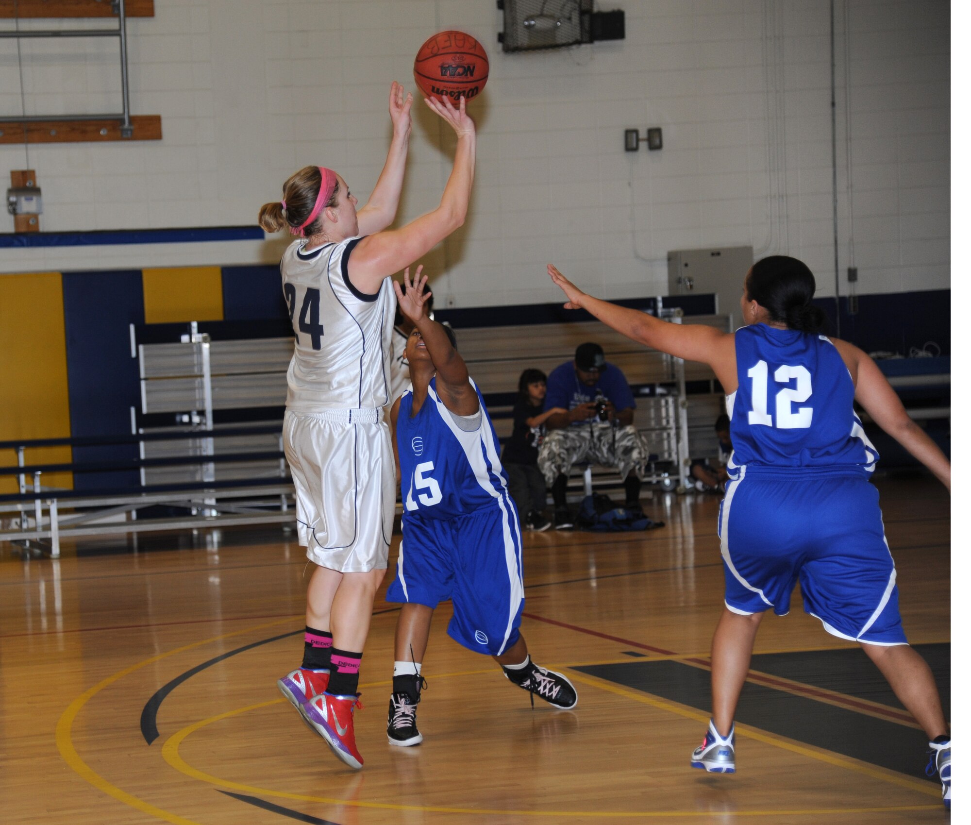 Sarah Newbauer, Keesler, takes a shot from inside the three-point line, as Shanika Ezell and Dameka McClendon, Eglin Air Force Base, Fla., attempt to block the shot during a women’s varsity basketball game Jan. 26, 2013, at the Blake Fitness Center, Keesler Air Force Base, Miss.  Keesler defeated Eglin, 85-42.  (U.S. Air Force photo by Kemberly Groue)