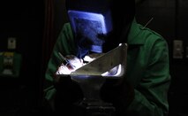 MINOT AIR FORCE BASE, N.D. – Airman 1st Class Allison Corbett, 5th Maintenance Squadron metals technician, welds a piece of metal here, Jan. 22. The 5th MXS’s Metals Technology Flight uses a lathe, drill press, torch and imagination to repair, and at times create, parts that are no longer available. (U.S. Air Force photo/Senior Airman Brittany Y. Auld)